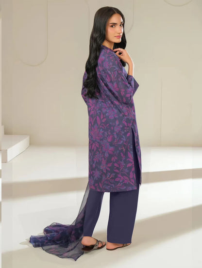 Woman wearing a purple floral outfit in a minimalistic setting