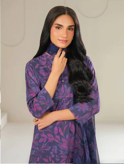 Woman wearing a purple floral dress against a neutral background