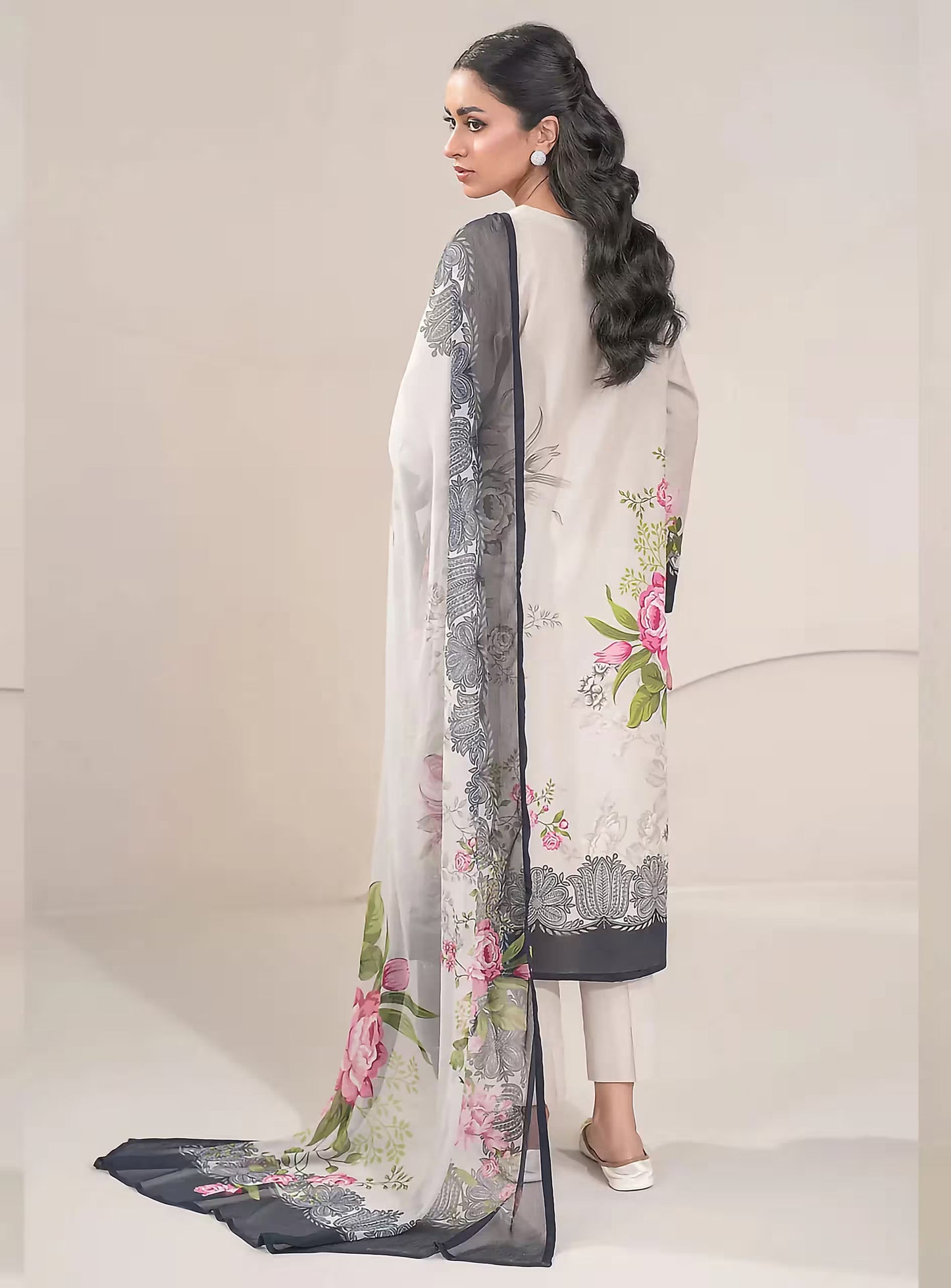Woman wearing a floral embroidered dupatta with a plain background
