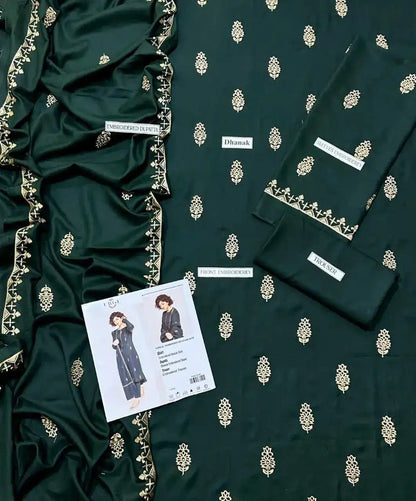 Dark green fabric with gold embroidery and a fashion label on a matching background