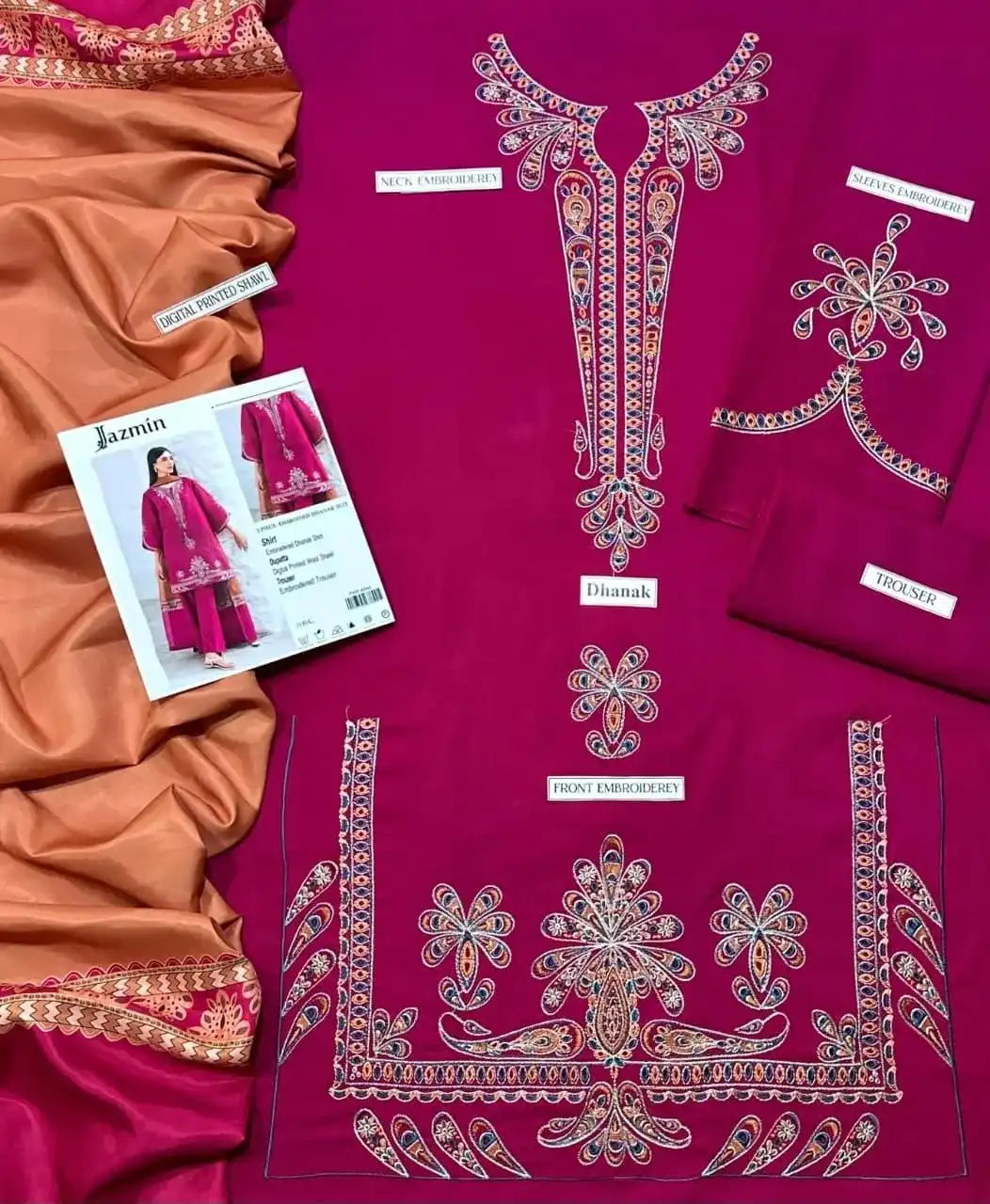 Purple embroidered fabric with intricate designs and a magazine featuring similar clothing.