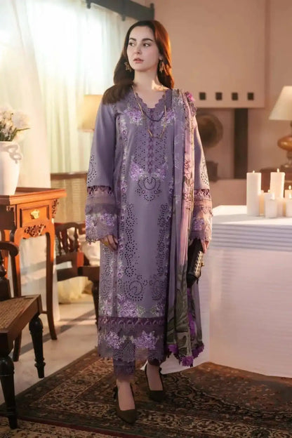 Woman in a purple embroidered outfit standing in a decorated room with candles and furniture.