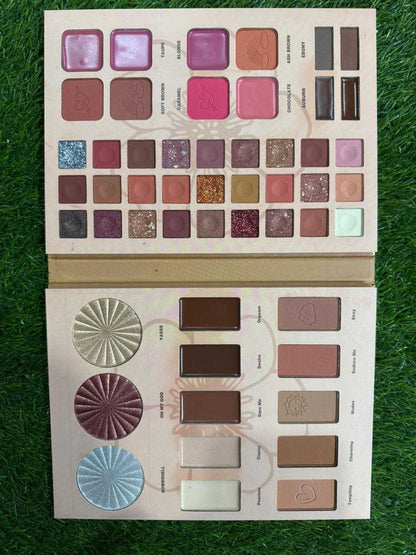 Makeup palette with various shades on a grass background