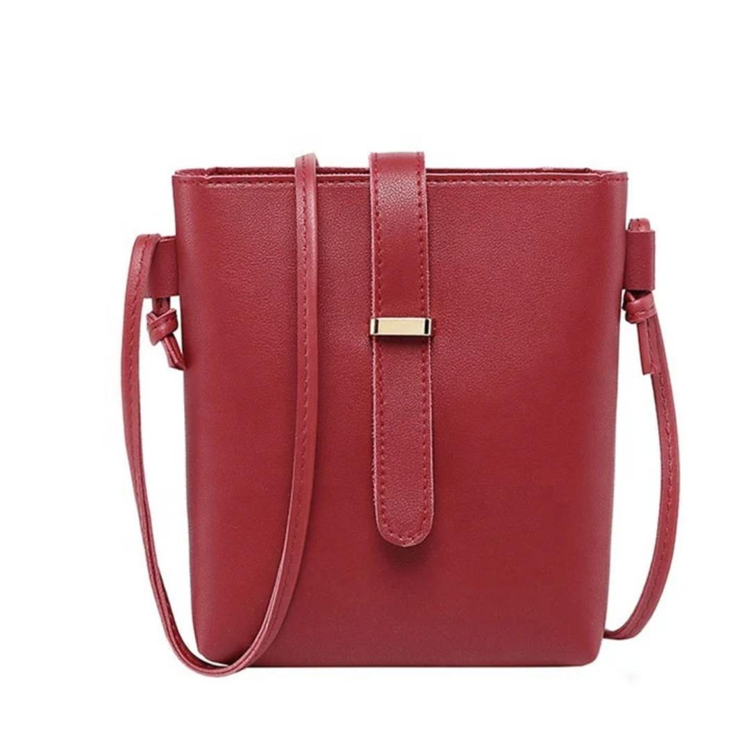 Red handbag with a strap on a white background