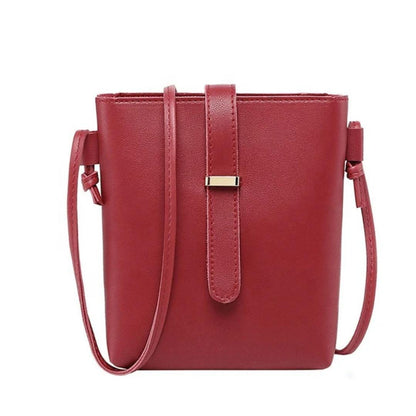 Red handbag with a strap on a white background