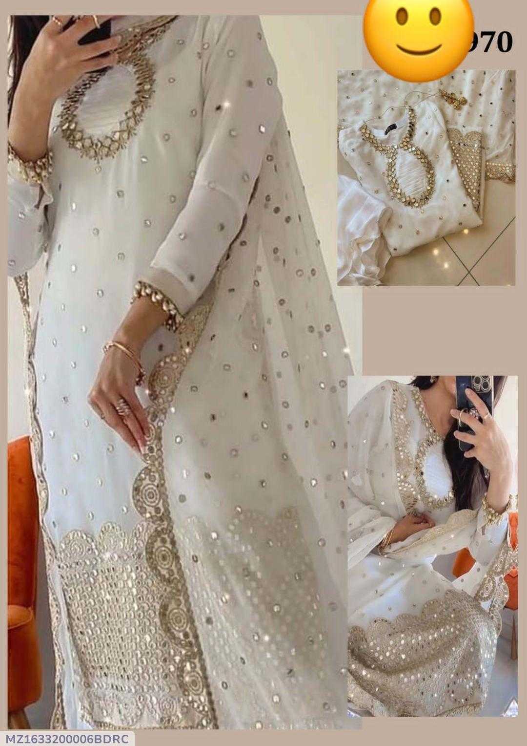 White traditional outfit with gold embroidery and jewelry on a beige background