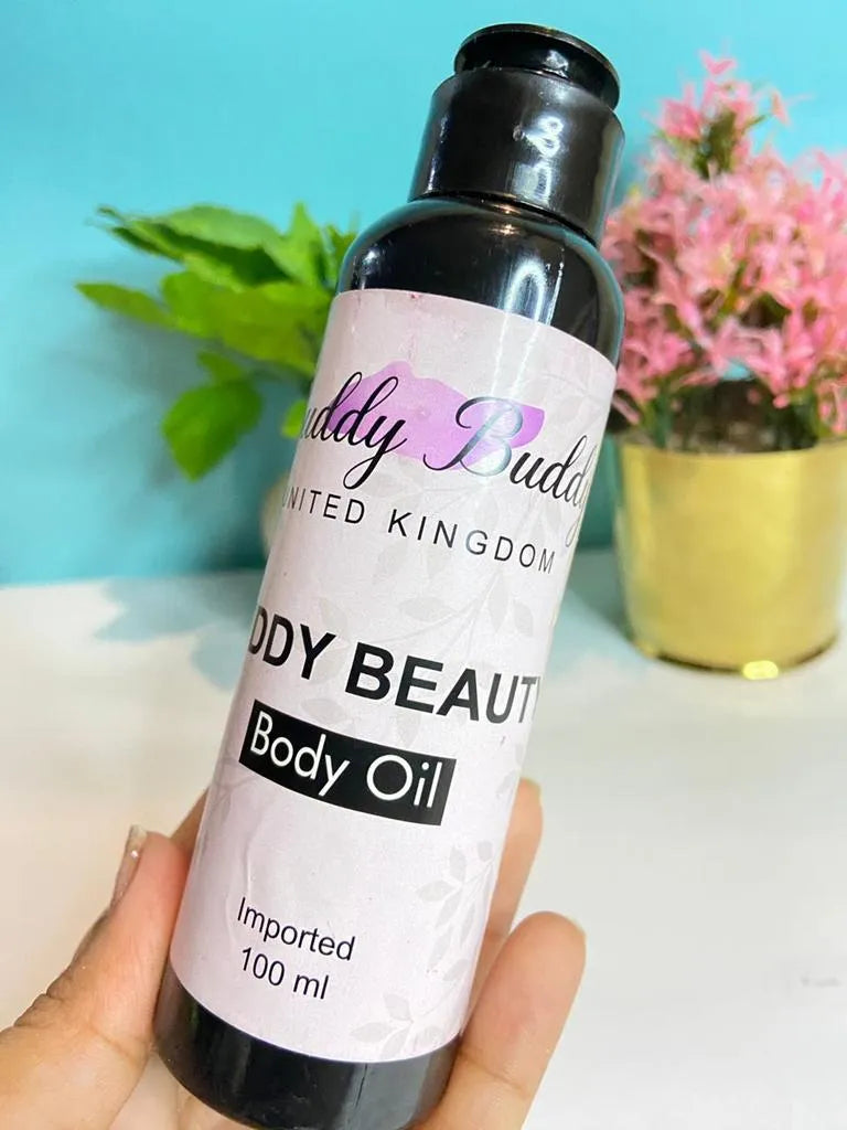 Bottle of 'Body Beauty' body oil held by a hand with a light blue background and plants.