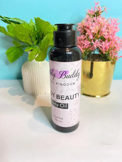 Body oil bottle labeled 'Body Beauty' on a table with decorative plants.