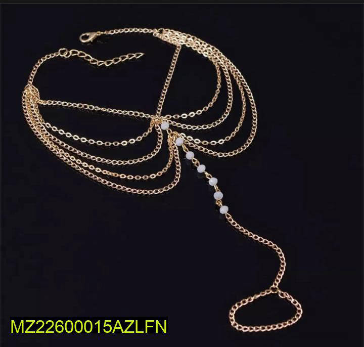 Gold chain necklace with beads on a black background