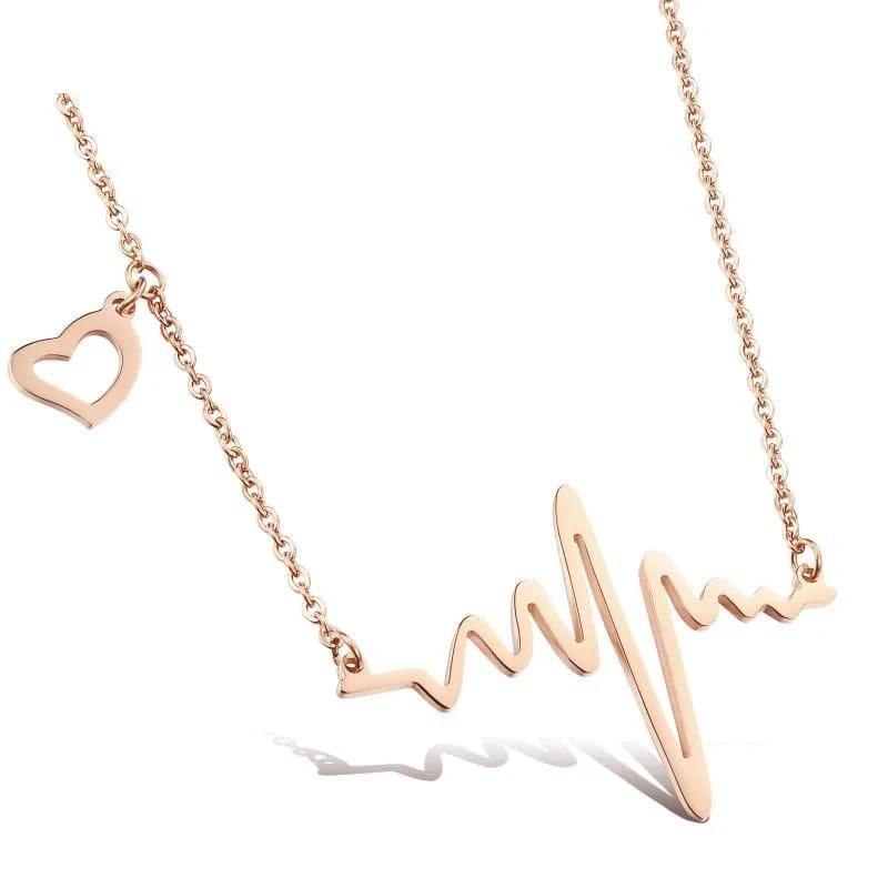Rose gold necklace with heart and heartbeat design on a white background