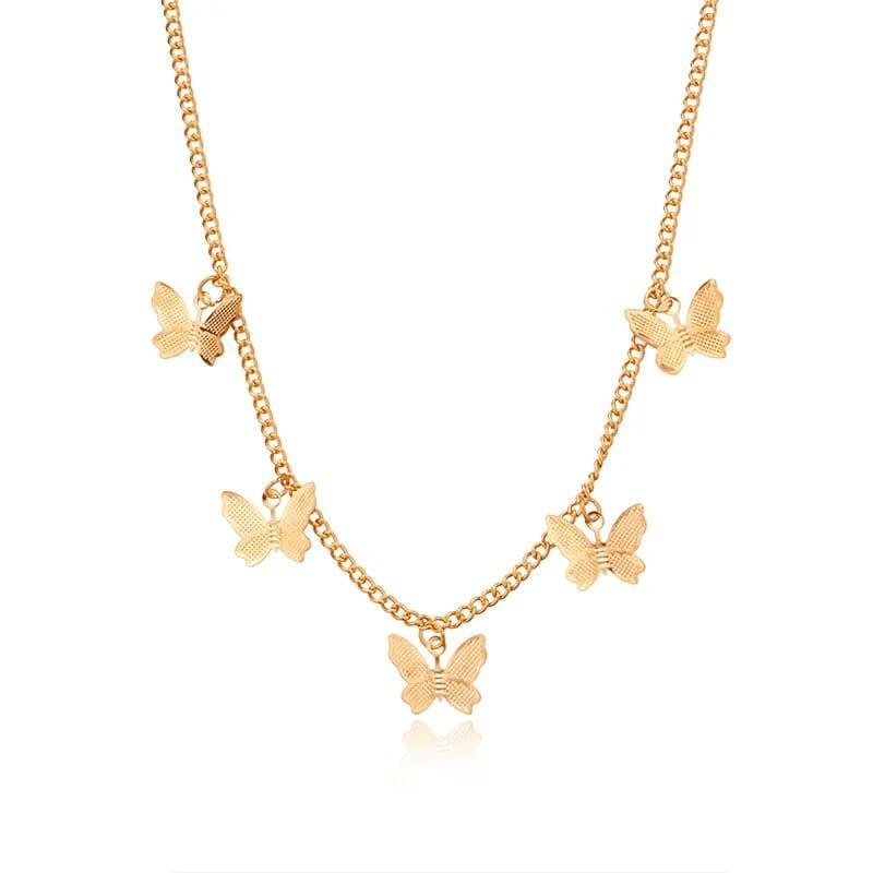Gold butterfly necklace on a white background