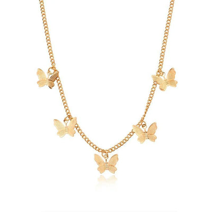 Gold butterfly necklace on a white background