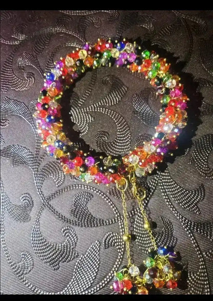 Colorful beaded necklace on a textured black background