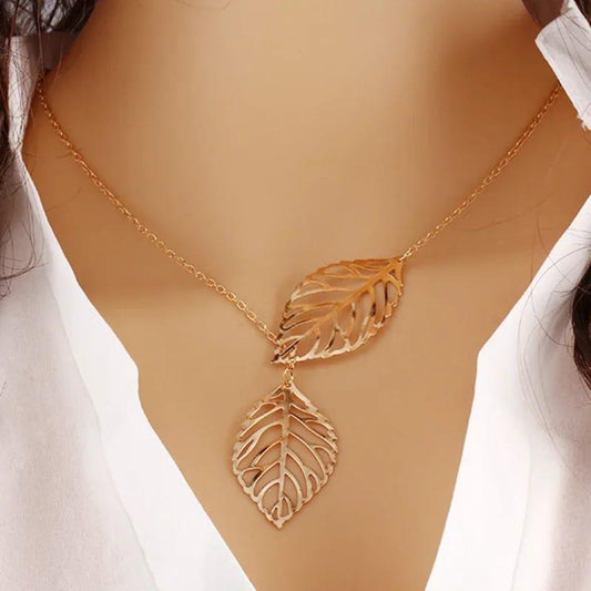 Gold leaf necklace on a mannequin with a white background