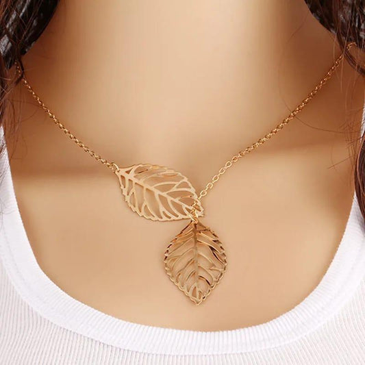 Gold leaf necklace on a mannequin with a white background