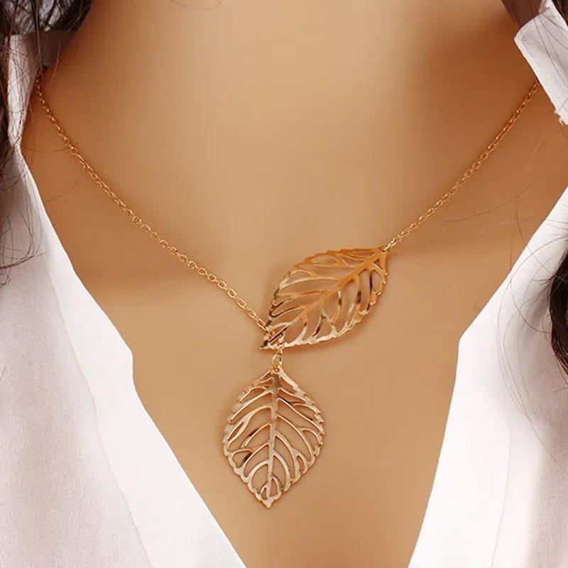 Gold leaf necklace on a mannequin with a white background