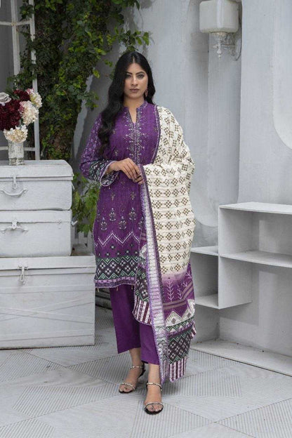 Woman in a purple traditional outfit with a white embroidered dupatta in a minimalistic setting.