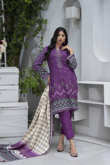Woman wearing a purple embroidered traditional outfit in an indoor setting with white walls and greenery.