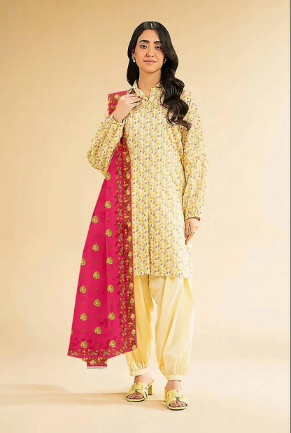 Woman wearing a yellow traditional outfit with a pink dupatta on a beige background