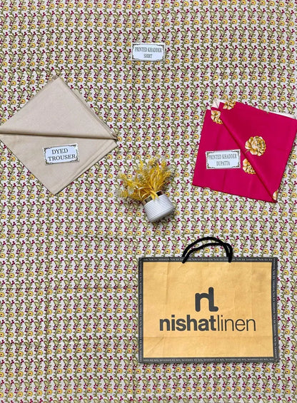 Fabric samples and a Nishat Linen bag on a patterned fabric background