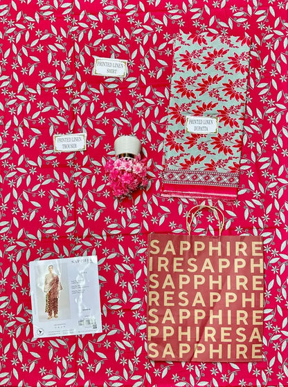 Red and white patterned fabric with 'Sapphire' branding and a small decorative item.