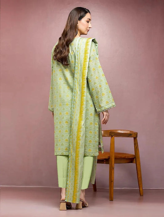 Woman wearing a green and yellow traditional outfit against a pink background