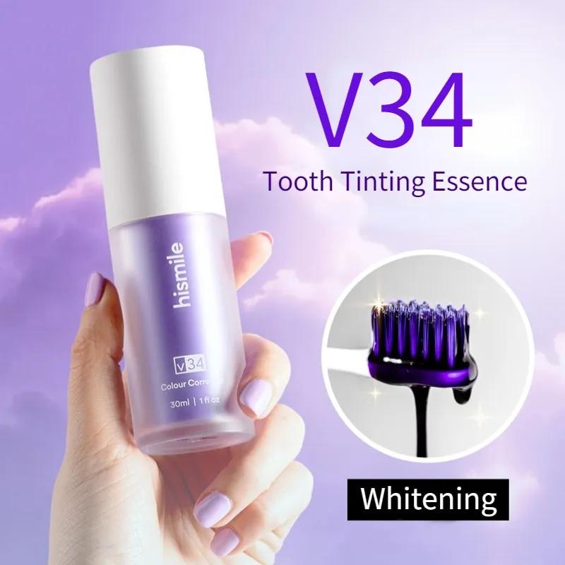 Hismile V34 Tooth Tinting Essence bottle held by a hand with a purple background