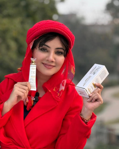 Woman in a red outfit holding skincare products outdoors