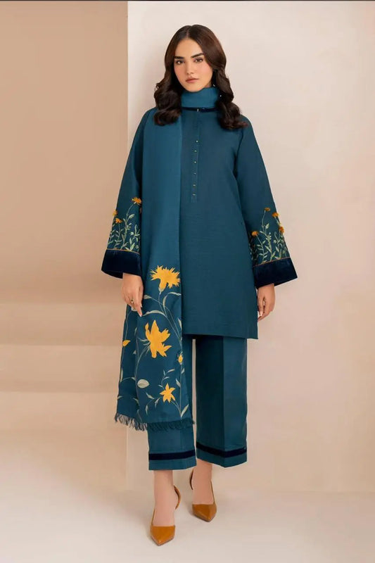 Woman wearing a teal outfit with floral patterns on a beige background