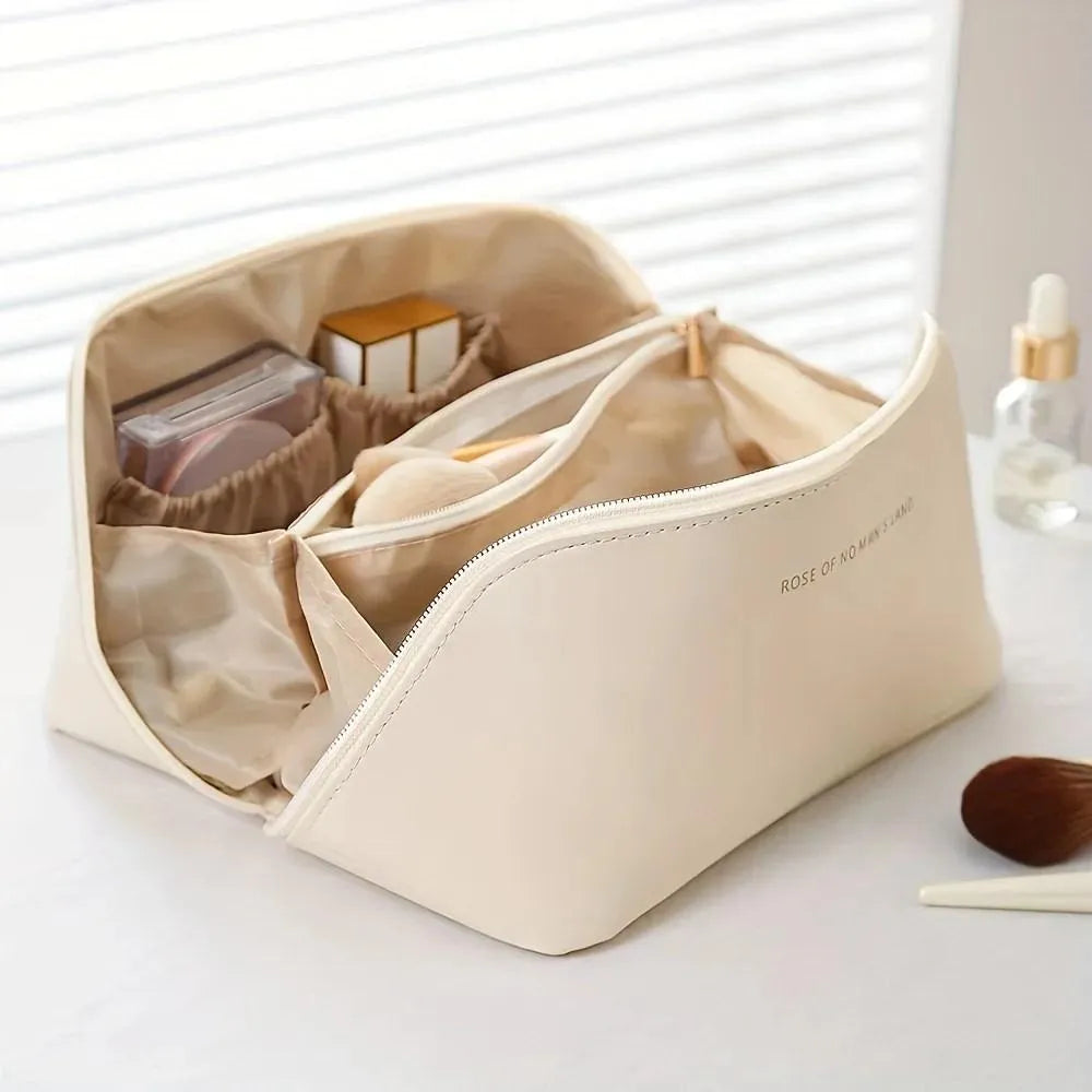 Beige cosmetic bag with compartments on a white surface