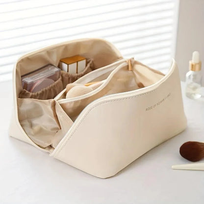 Beige cosmetic bag with compartments on a white surface