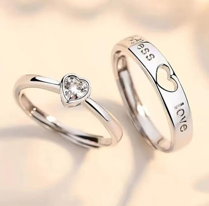 Two silver rings with heart designs on a soft background