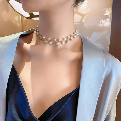Pearl necklace worn by a model against a neutral background