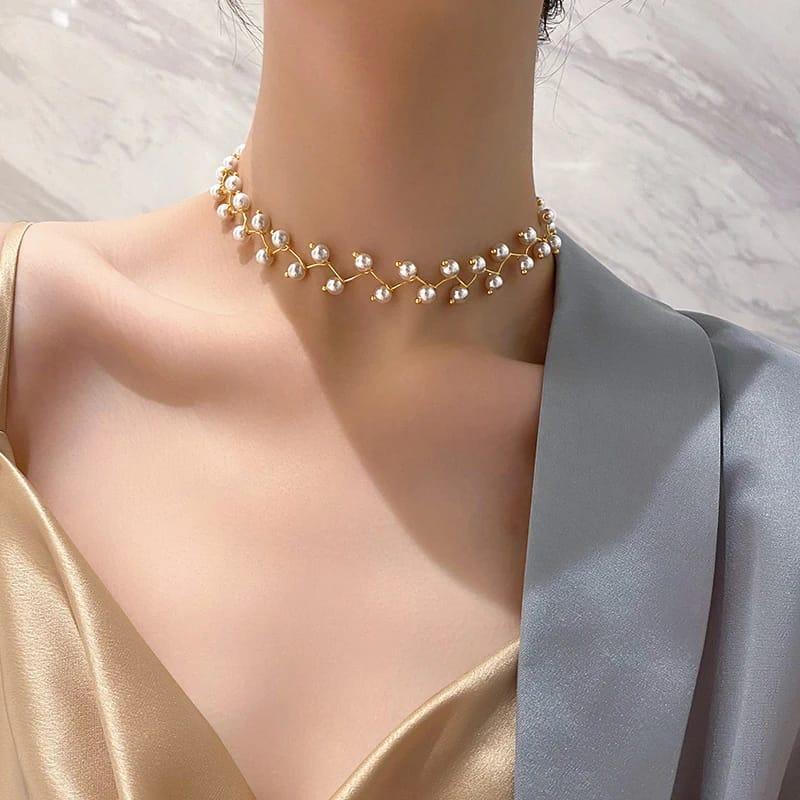 Pearl choker necklace worn by a model against a neutral background