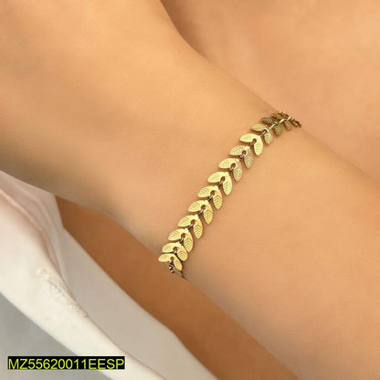 Gold bracelet on a wrist with a blurred background