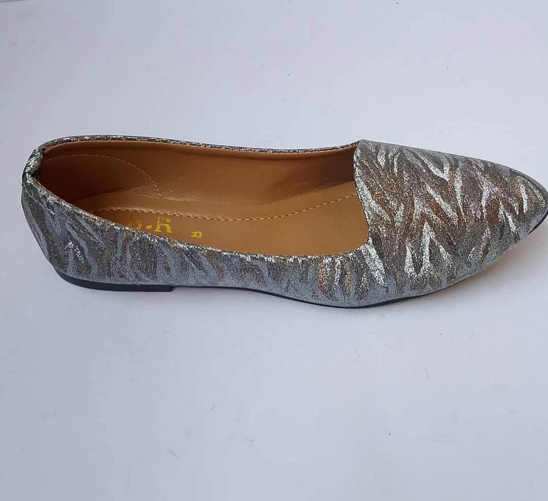 Silver glittery flat shoe on a white background