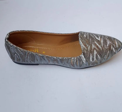 Silver glittery flat shoe on a white background