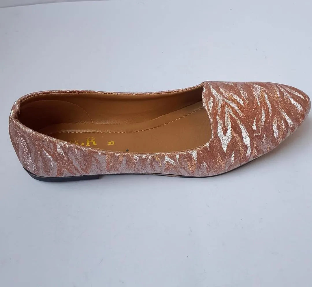 Flat shoe with a patterned design on a white background