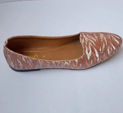 Flat shoe with a patterned design on a white background