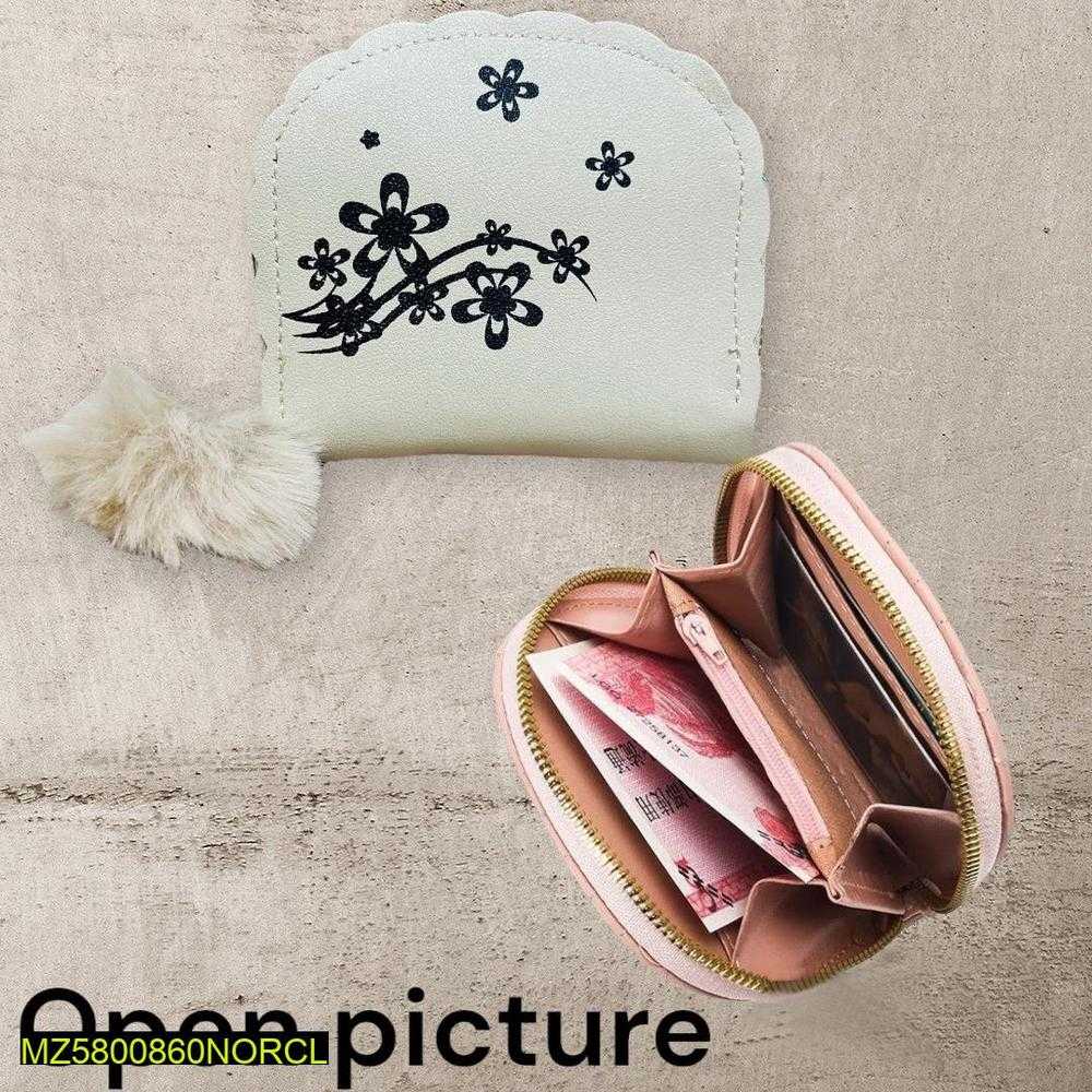 Small white pouch with black floral design and a pink zipper pouch with money on a textured beige surface.