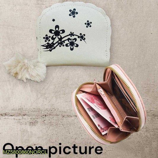 Small white pouch with black floral design and a pink zipper pouch with money on a textured beige surface.