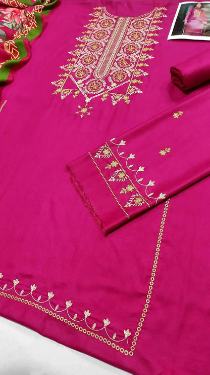 Pink embroidered fabric with intricate patterns on a white background