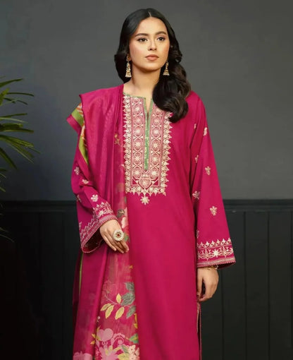 Woman wearing a pink embroidered traditional outfit against a dark background