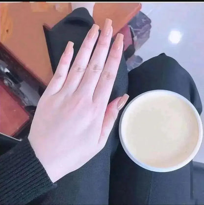 Hand holding a cup of coffee with a blurred background