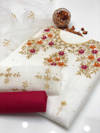 White fabric with floral embroidery and a red fabric underneath on a white background