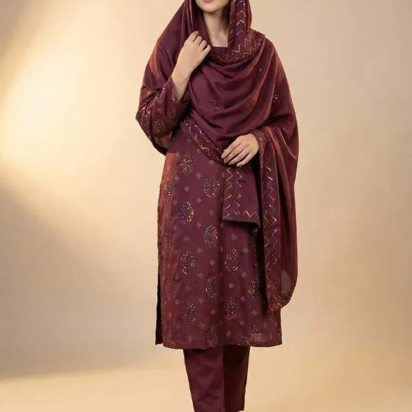 Maroon traditional outfit with a matching dupatta on a beige background