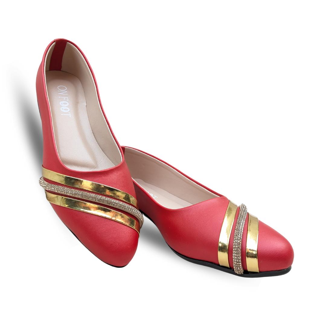 Red shoes with gold bands and rhinestones on a white background