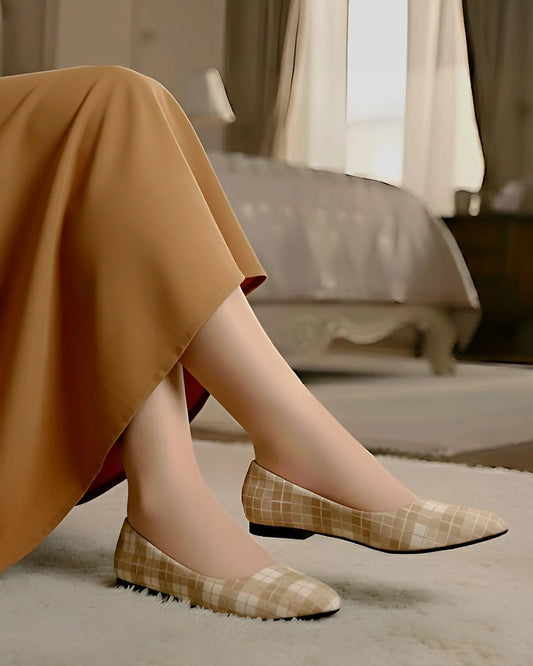 Person wearing plaid shoes in a home setting