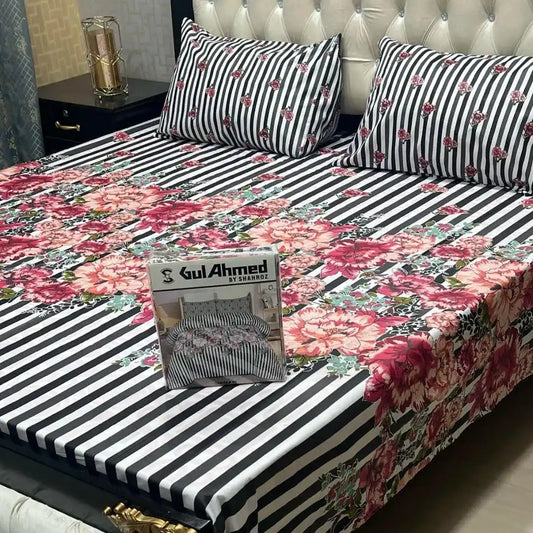Floral and striped bedspread with a packaging box on a bed