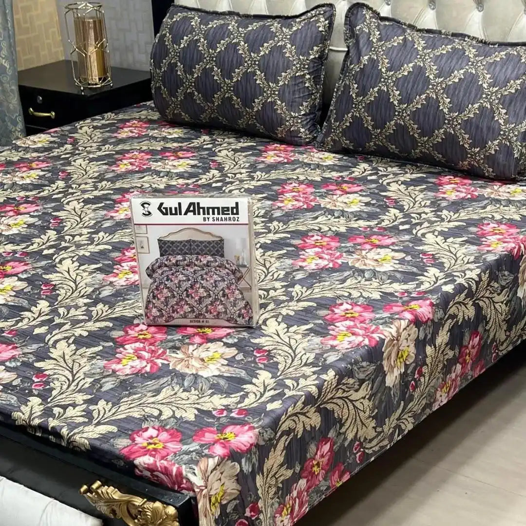 Floral patterned bedspread with 'Gul Ahmed' packaging on a bed